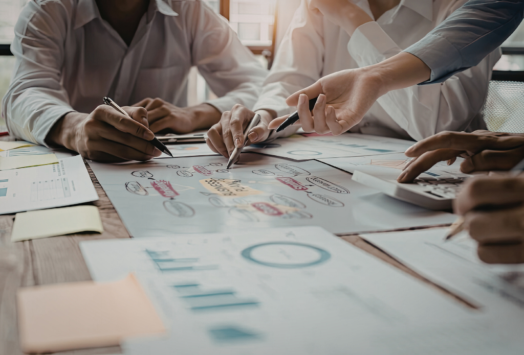 Marketing professionals reviewing analytics charts and laptop data to make better data-driven marketing decisions for pipeline growth.