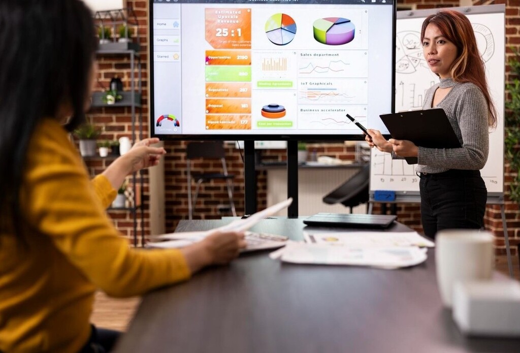 Team reviewing performance dashboards illustrating GTM strategy execution challenges in B2B organizations